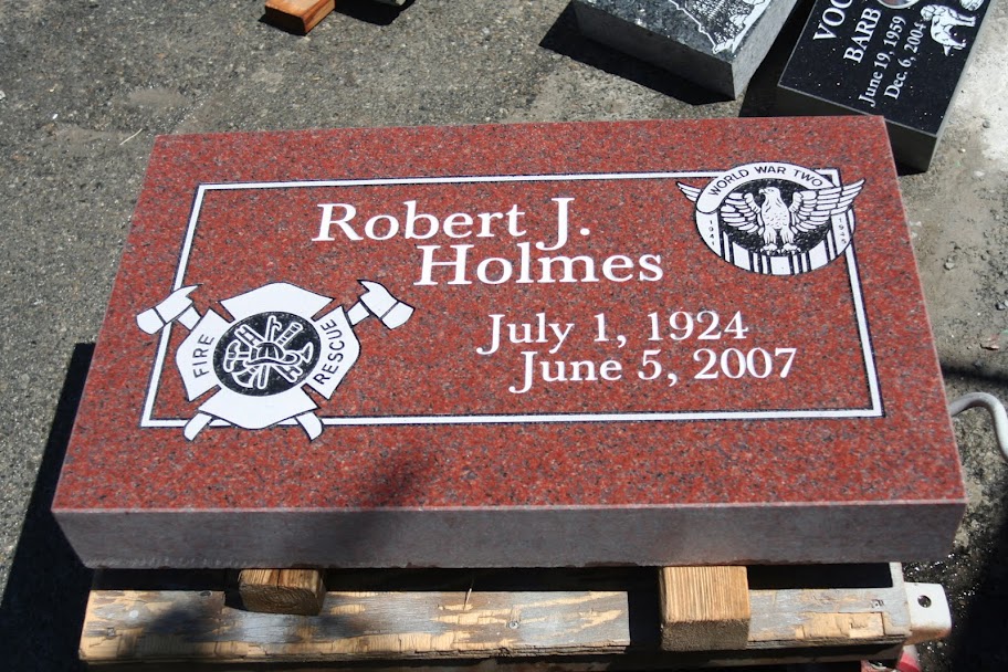Flat grave marker in Imperial red granite with custom emblems Pacific